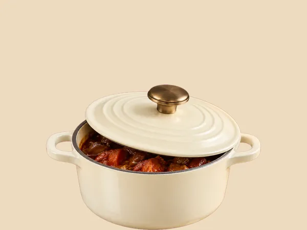 A small cream lidded dish of leftovers.